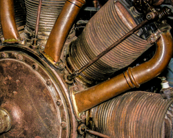 Old airplane engine forms a copper sculpture.