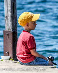 The summer waters of Green Bay provide a pleasant afternoon's fishing for a Door County, WI, boy.